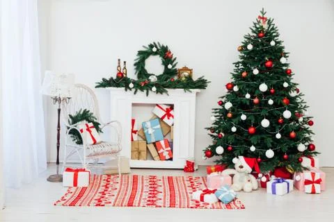 Christmas tree pine with fireplace interior of the house new year decor gifts 스톡 사진