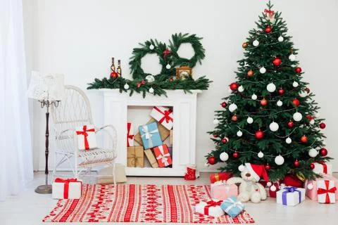 Christmas tree pine with fireplace interior of the house new year decor gifts Фото