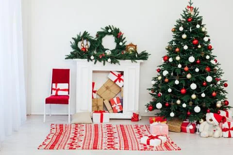 Christmas tree pine with fireplace interior of the house new year decor gifts Stock Photos