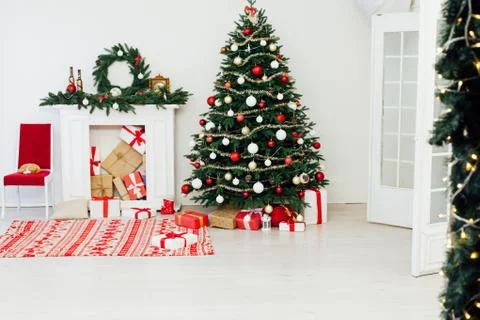 Christmas tree pine with fireplace interior of the house new year decor gifts Stock Photos