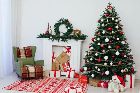Christmas tree pine with fireplace interior of the house new year decor gifts Stock Photos