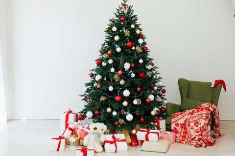 Christmas tree pine white interior room new year decor garland gifts postcard Stock Photos