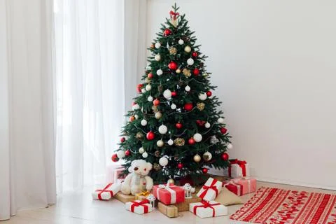 Christmas tree pine white interior room new year decor garland gifts postcard Stock Photos