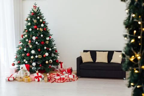 Christmas tree pine white interior room new year decor garland gifts postcard Stock Photos