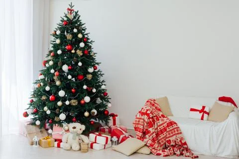 Christmas tree pine white interior room new year decor garland gifts postcard Stock Photos