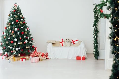 Christmas tree pine white interior room new year decor garland gifts postcard 스톡 사진