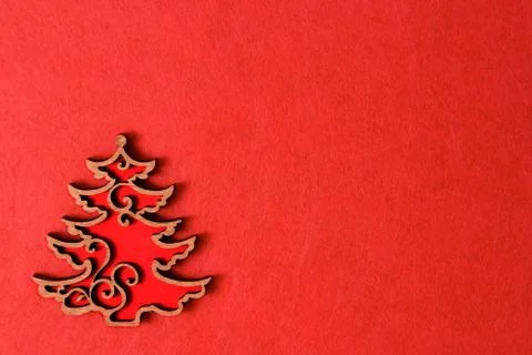 Christmas tree on the red background of the texture, wooden eco decoration, toy Stock Photos