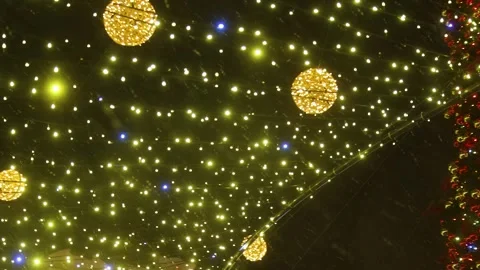 Christmas Tree with Red Baubles and Golden Light Canopy in Falling Snow Stock Footage 346137238