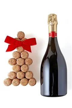 Christmas tree with red bow made of champagne corks and bottle of sparkling.. Stock Photos