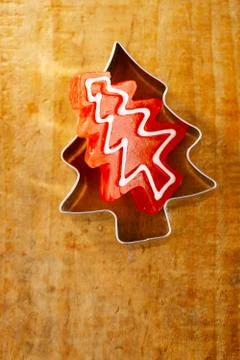 Christmas tree red candy in cookie cutter, wooden background Stock Photos