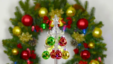 Christmas tree rotates against the background of a large Christmas wreath Stock Footage 201917251