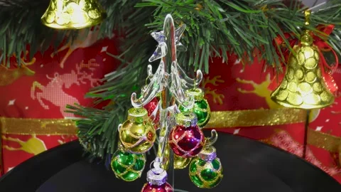 Christmas tree rotates on the background of a green Christmas tree and gifts Stock Footage 202185694