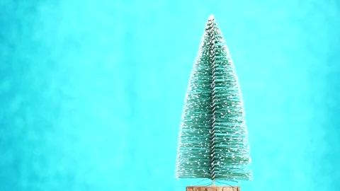 Christmas tree rotating on the blue background. Winter Holidays background Stock Footage 257406619