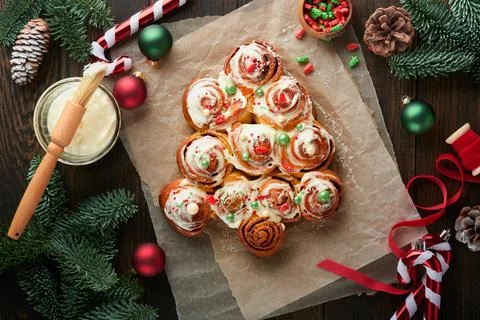 Christmas tree shape cinnamon rolls or cinnabon buns with cinnamon and cream  Stock Photos