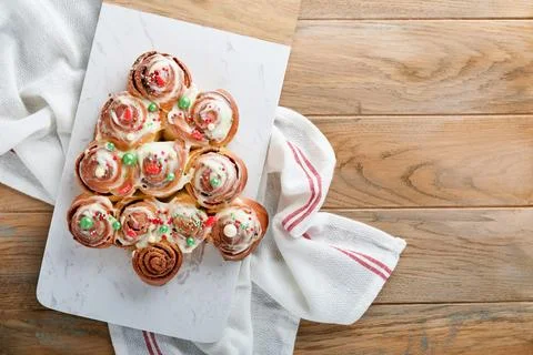 Christmas tree shape cinnamon rolls or cinnabon buns with cinnamon and cream  Stock Photos