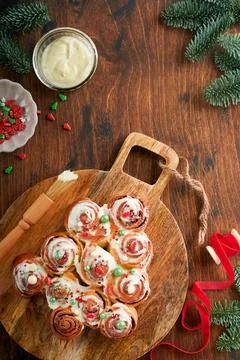 Christmas tree shape cinnamon rolls or cinnabon buns with cinnamon and cream  Stock Photos