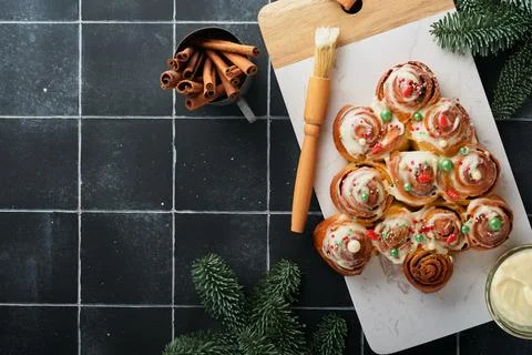 Christmas tree shape cinnamon rolls or cinnabon buns with cinnamon and cream  Stock Photos