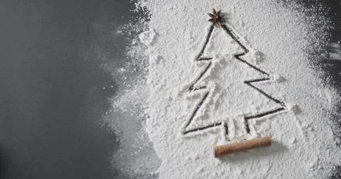 A Christmas tree shape is drawn in flour on a dark surface, with copy space Stock Illustration