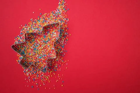 Christmas tree shape form and scattering multicolored confectionery topping Stock Photos
