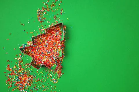 Christmas tree shape form and scattering multicolored confectionery Stock Photos