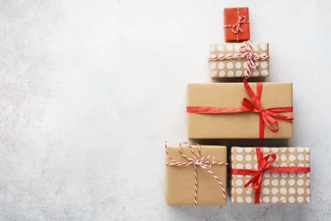 Christmas tree shape made of gift boxes on light gray background Stock Photos