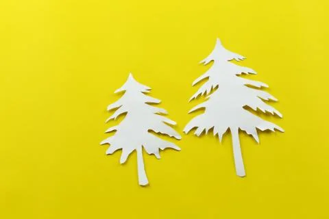 Christmas tree shape of white paper on yellow paper background. Stock Photos