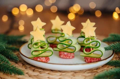 Christmas tree-shaped appetizer with cheese, cucumber, and salami Stock Photos