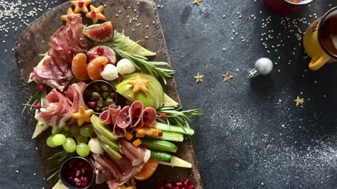 Christmas tree shaped cheese and charcuterie board with dark background.  Stock Footage 345634873