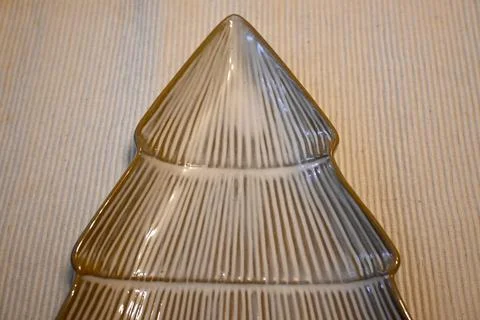 Christmas tree shaped serving dish on ribbed textile Stock Photos