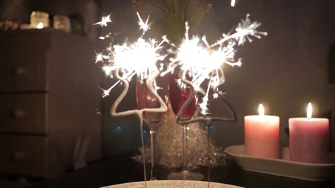 Christmas tree shaped sparkles with two glasses of champagne and candles 스톡 동영상 72572944