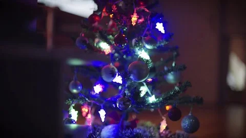 Christmas tree sparkling in the low-lit room. Slider shot. Stock Footage 70354837
