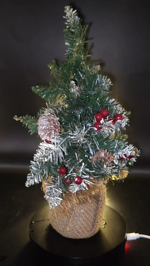 Christmas tree spinning on a dark background Stock Footage 323760895