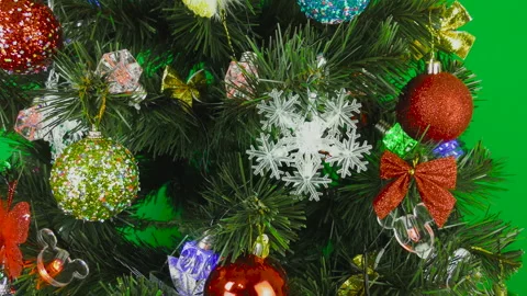 Christmas tree spinning on a green background Stock Footage 147235250