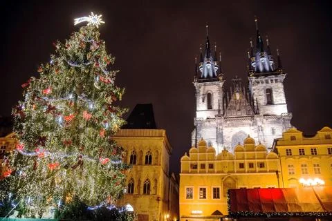 Christmas tree in square behind old tower Stock Photos