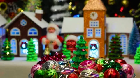 Christmas tree surrounded by decorations rotates against of a Christmas town Stock Footage 292877297