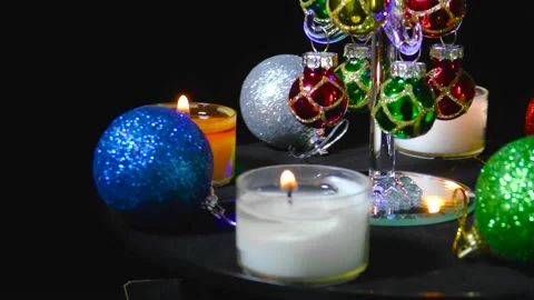Christmas tree surrounded by multi-colored New Year's burning candles and balls Stock Footage 162628319