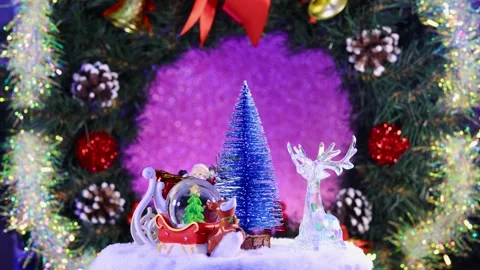 A Christmas tree surrounded by Santa Claus, a deer and a glass ball Stock Footage 283526428