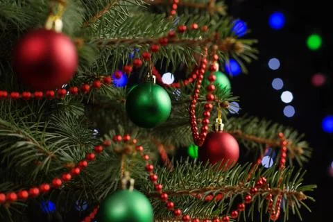 Christmas tree, on the table, against the background of blurry lights, bokeh. Stock Photos