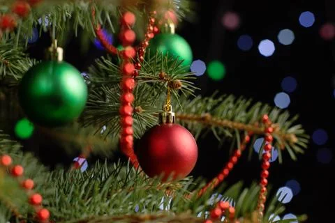 Christmas tree, on the table, against the background of blurry lights, bokeh. Stock Photos