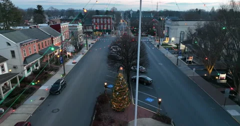 Christmas tree on town square decorated with lights. Descending aerial at Stock Footage 168361253