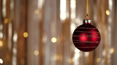 Christmas tree toy red ball hanging on golden festive background closeup. Stock Footage 259010751