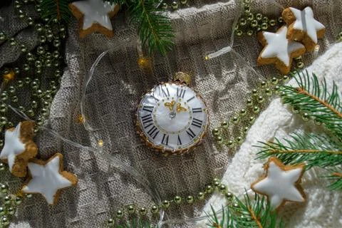 Christmas tree toy in the shape of a clock among the branches of a spruce Stock Photos