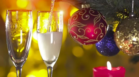 Christmas tree with two glasses and pouring champagne Stock Footage 56733175