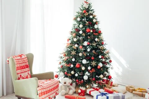 Christmas tree by the window with gift decor for the new year interior holiday Stock Photos