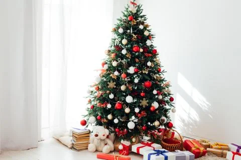Christmas tree by the window with gift decor for the new year interior holiday Stock Photos