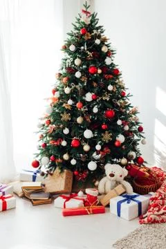 Christmas tree by the window with gift decor for the new year interior of the Stock Photos