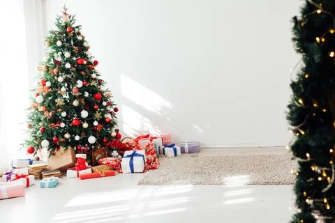 Christmas tree by the window with gift decor for the new year interior of the Stock Photos