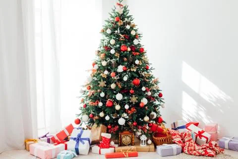 Christmas tree by the window with gift decor for the new year interior of the Stock Photos