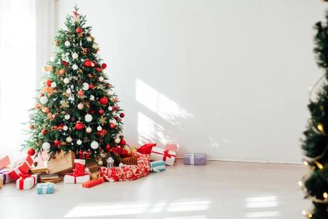 Christmas tree by the window with gift decor for the new year interior of the Stock Photos