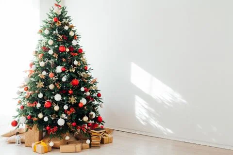 Christmas tree by the window with gift decor for the new year interior of the Stock Photos